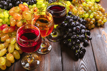 木桌上有白葡萄分枝的葡萄酒
