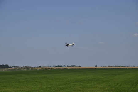 飞机农业航空 An2。喷洒肥料和杀虫剂在领域与航空器