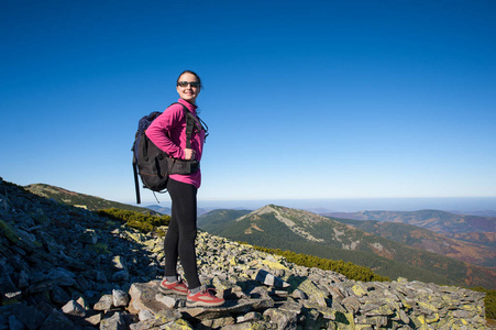 女人在洛基山的山峰上的背包客