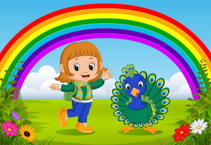 可爱的女孩和孔雀在公园与彩虹场面