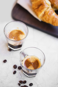咖啡杯配牛角面包。早晨咖啡和早餐