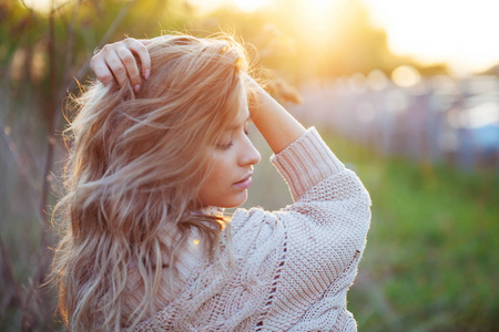 夏天在田野里可爱迷人的女孩。年轻妇女是愉快