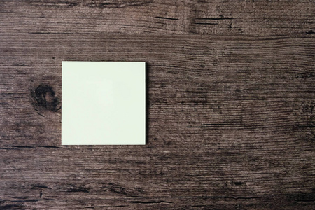 在木桌上的空白粘纸条纸的顶部视图图像