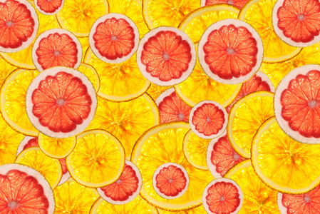 粉红葡萄柚和橘子混合五颜六色的切片的水果背景