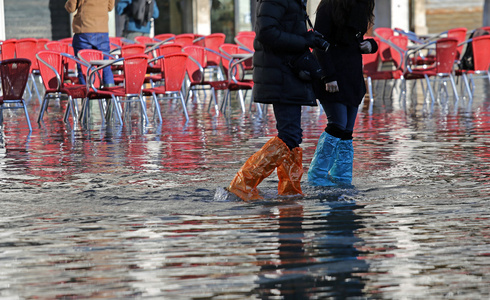 紧身裤和靴子在涨潮在威尼斯的人