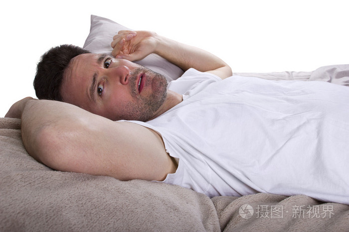 饱受失眠之苦,躺在床上的男人照片-正版商用图片0v8