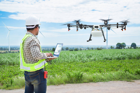 技术员使用 wifi 上网计算机控制农业无人机在蔗田