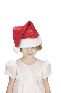 圣诞老人的帽子戴上白色孤立她眼睛的可爱 toodler 女孩