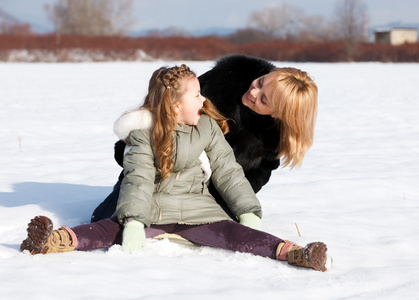 母亲和她的小女儿享受美丽的冬日