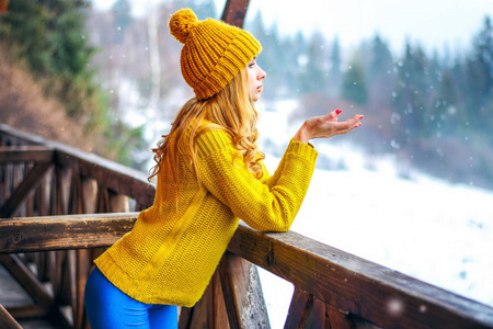 小女孩穿着毛衣和帽子抓到雪图片