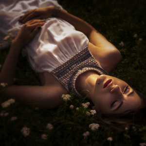 美丽的黑发女人，睡在草和花