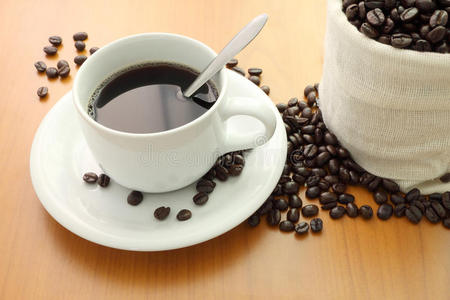 一杯咖啡和袋装咖啡豆图片