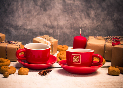 两个红色的咖啡杯子，一颗心和礼品的形状的饼干