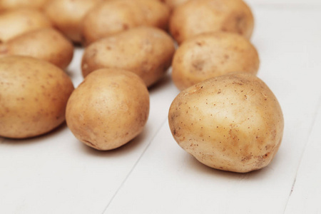 白色的木桌上的新土豆的特写
