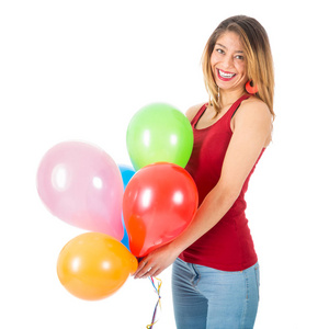 漂亮的女人抱着五颜六色的气球，白色背景上孤立