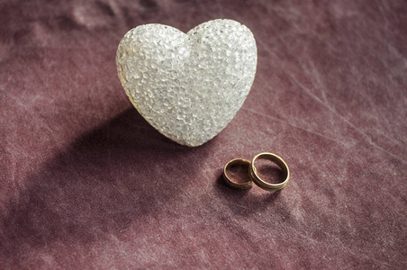爱情 婚礼和情人节的概念。美丽的金戒指和玻璃心选择性焦点。有用的贺卡