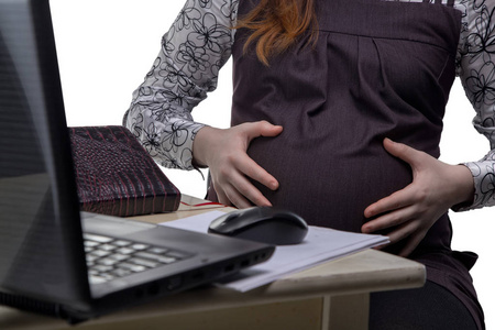 孕妇在办公室中拥抱肚皮