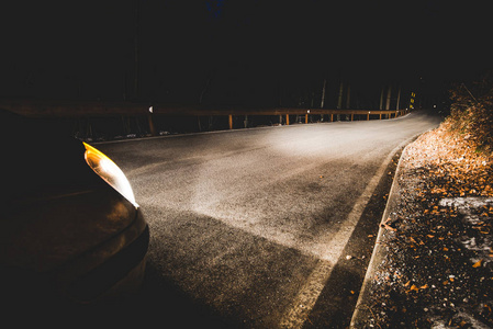 夜间山路上一辆汽车的大灯图片