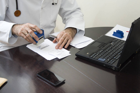 s hand stamped on the prescription. The doctor writes a prescrip