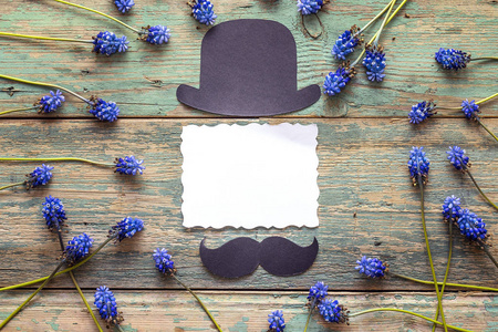 空纸卡与纸板的帽子和小胡子和蓝色的花