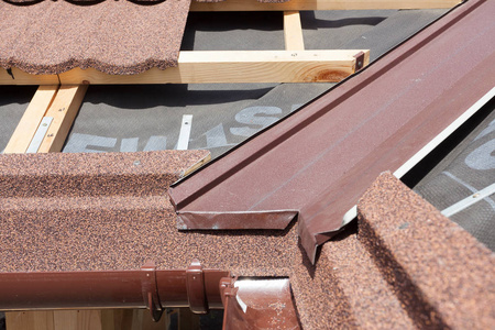 新沥青瓦屋顶与棕色雨装订线 木梁和蒸气控制层