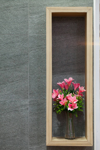 美丽的鲜花在木墙背景上有一个玻璃花瓶