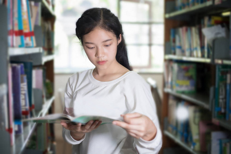 亚洲女学生选择抱着书在图书馆