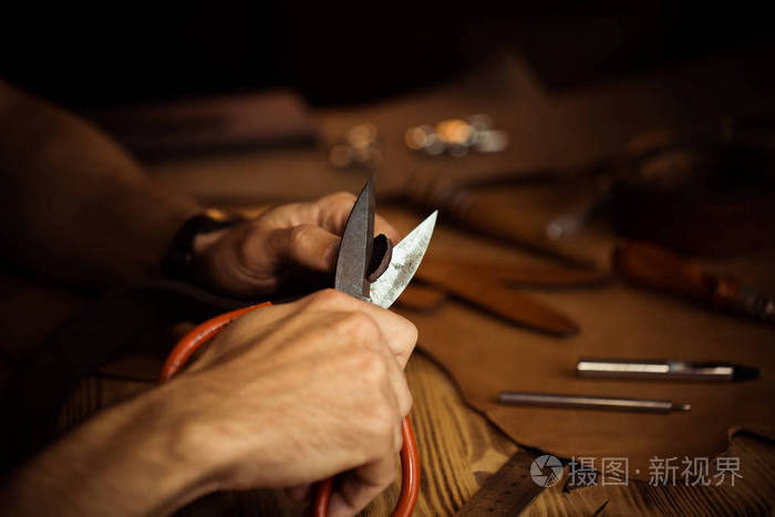 皮带在皮革车间工作过程人控股手工制作工具和工作坦纳在老制革厂木桌