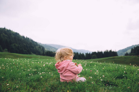 小女孩坐在草地上