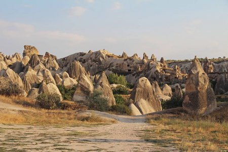 自然谷与凝灰岩石岩石在格雷梅在土耳其, 在日落