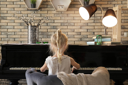 在室内弹钢琴的小女孩