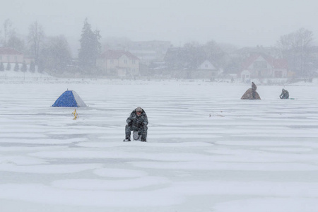 渔民在冬天在冰上捕鱼图片