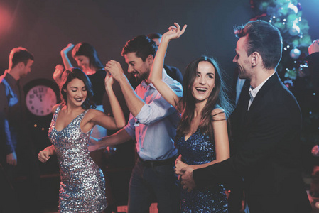 s party. In the foreground, a guy and a girl are dancing. The gi