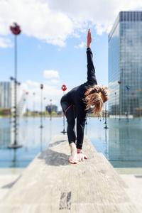 女人做瑜伽在城市环境中，巴黎湖附近