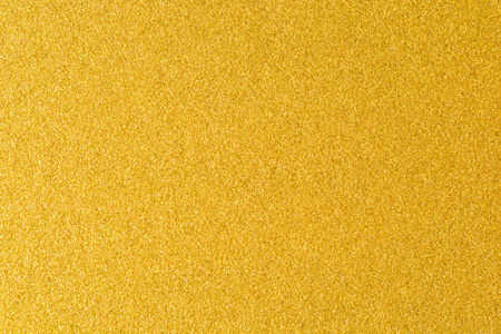 金色纹理背景的细节。金色的彩漆墙。奢华的金色背景和墙纸。金箔纸或包装纸