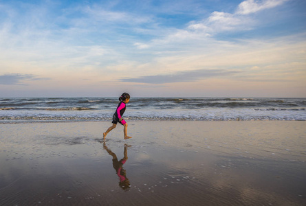 小运动模糊图像。小女孩在海滩上奔跑