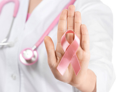 医生在白色背景上显示粉红色丝带。乳癌意识概念