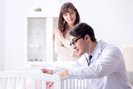 Doctor examining sick little boy