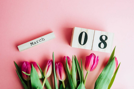 s Day concept. With wooden block calendar and pink tulips on pin