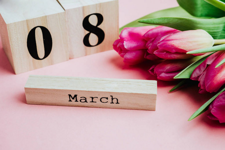 s Day concept. With wooden block calendar and pink tulips on pin