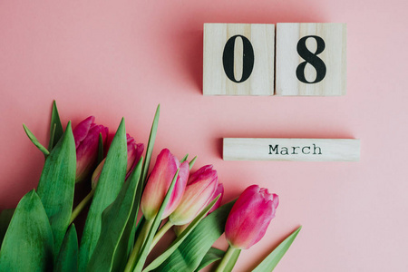 s Day concept. With wooden block calendar and pink tulips on pin