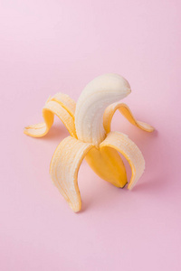 剥皮香蕉粉红色背景与复制空间图片