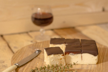 s milk souffle cake with glass of liquor on wooden table 