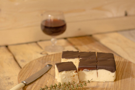 s milk souffle cake with glass of liquor on wooden table 