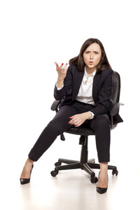 愤怒的女商人坐在办公室椅子上，在白色背景下大喊大叫