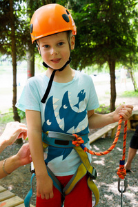 男孩爬上了一个绳索公园。