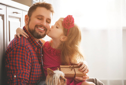 s day. Happy family daughter giving dad a greeting card on holid