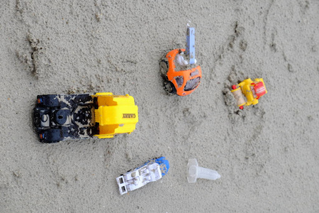  shoes are placed at the beach.The sand toys and toys are placed