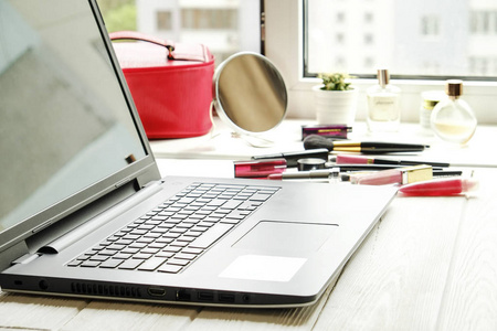 s table with blank screen laptop computer and beauty accessories