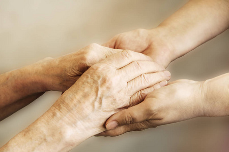  care giver, hands close up. Grand mother everyday life. Backgro